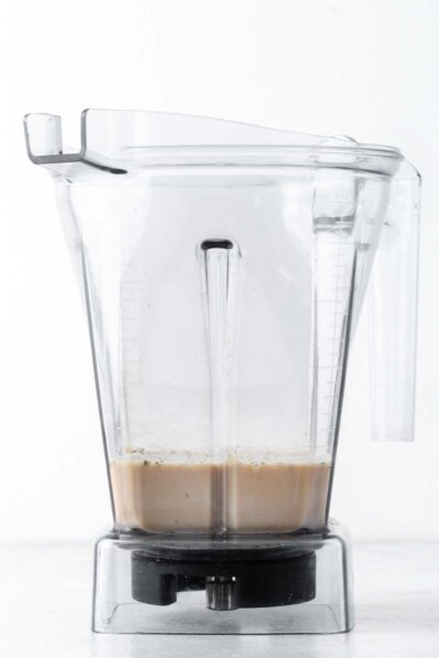 Hemp seeds, coffee, and oat milk in a blender. 
