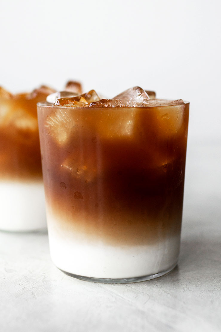 Layered iced coffee with milk on the bottom and cold brew coffee on top