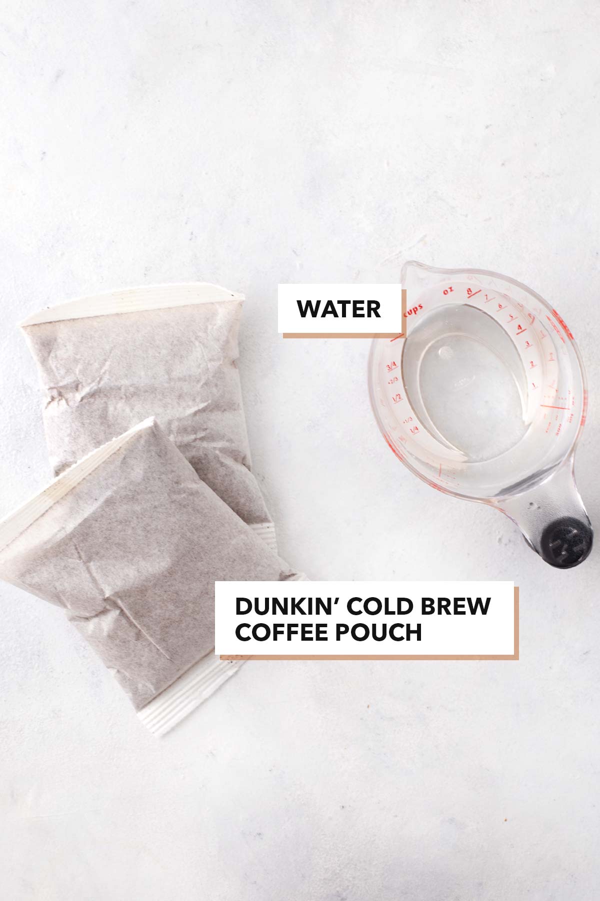 Dunkin' Cold Brew Copycat ingredients in pouches and a clear measuring cup.