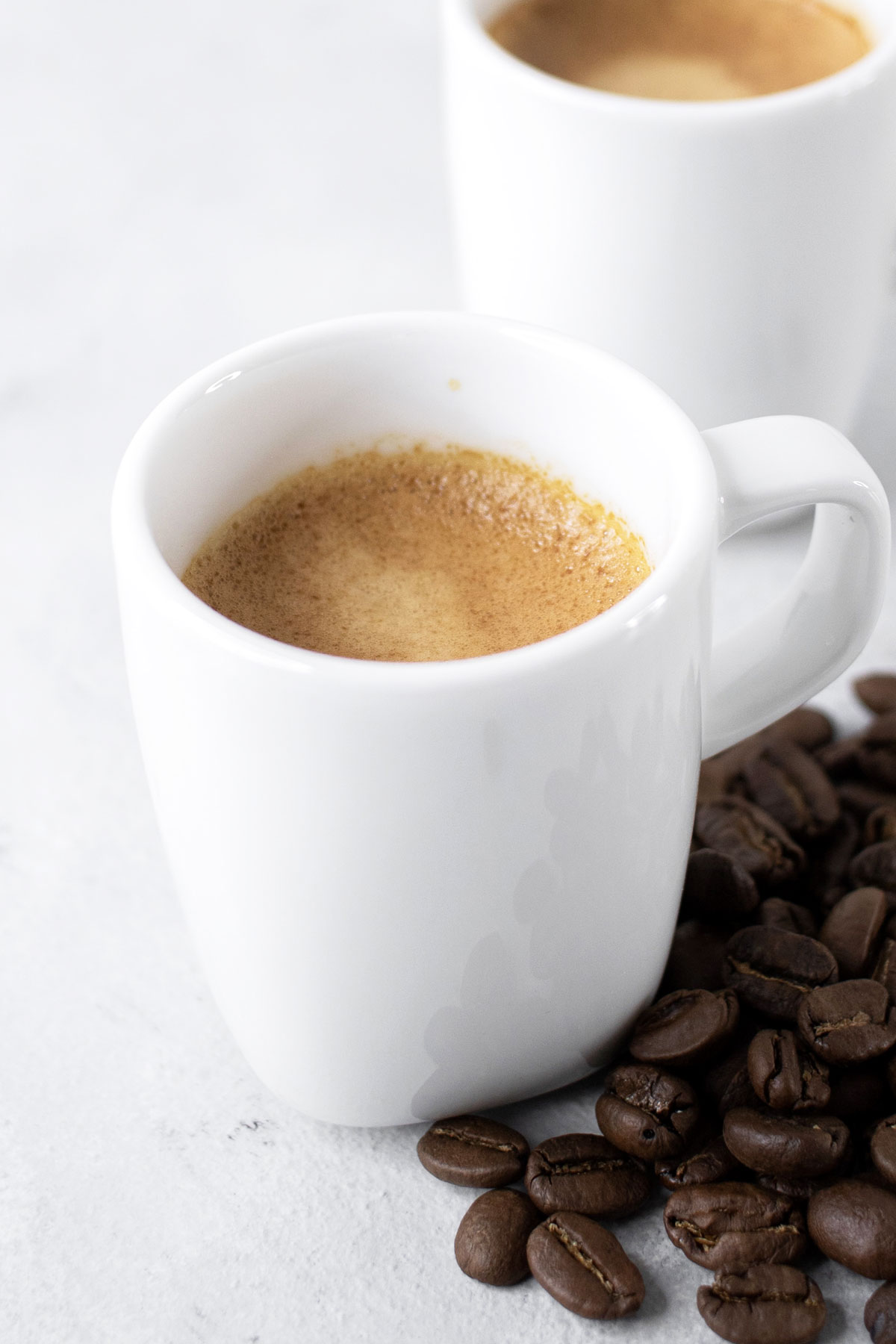 Espresso in small white mugs.