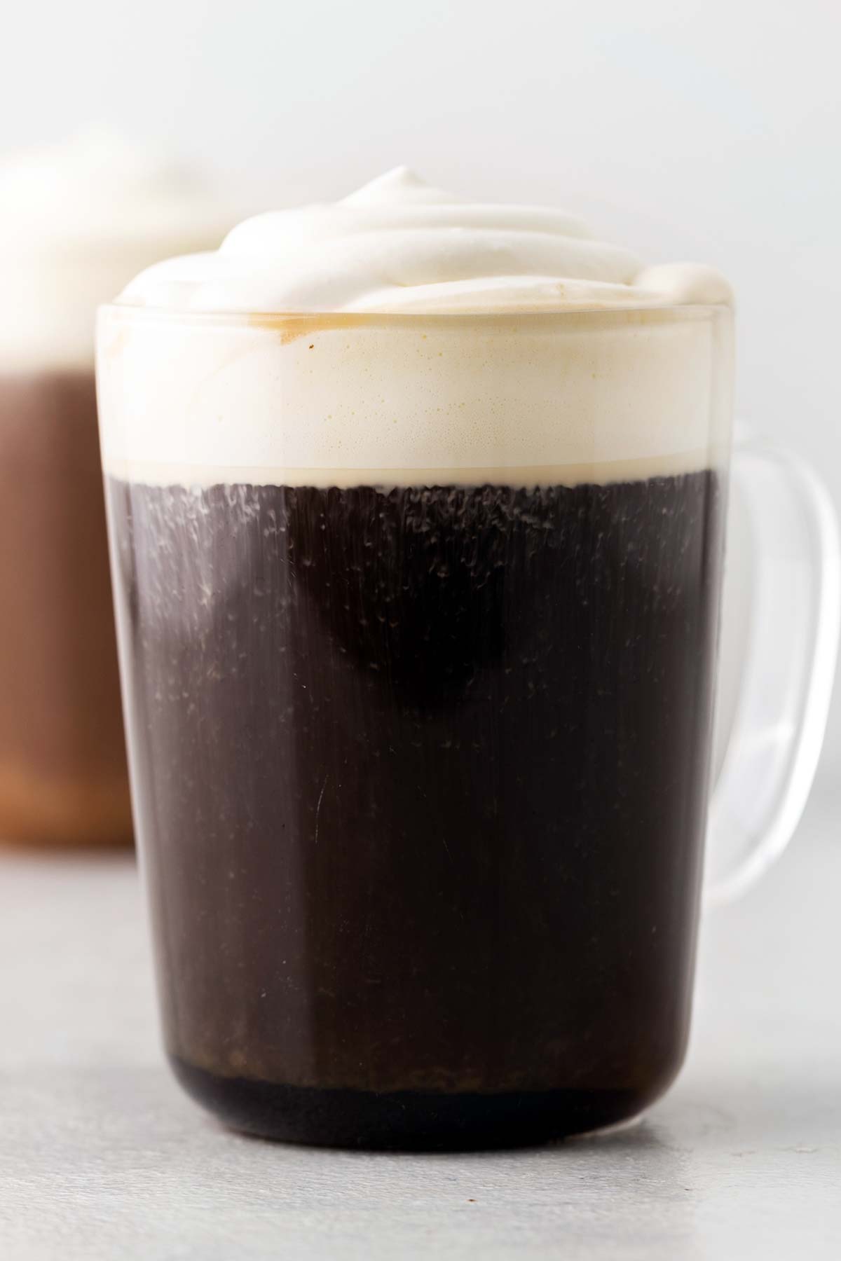 A completed Irish coffee with a generous dollop of soft cream on top.