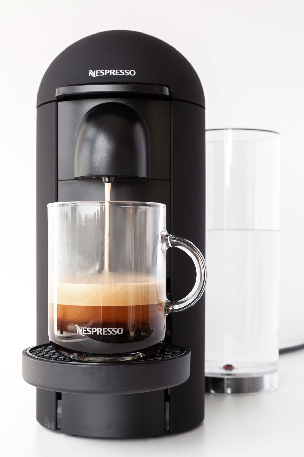 Nespresso VertuoPlus machine making coffee into a mug.