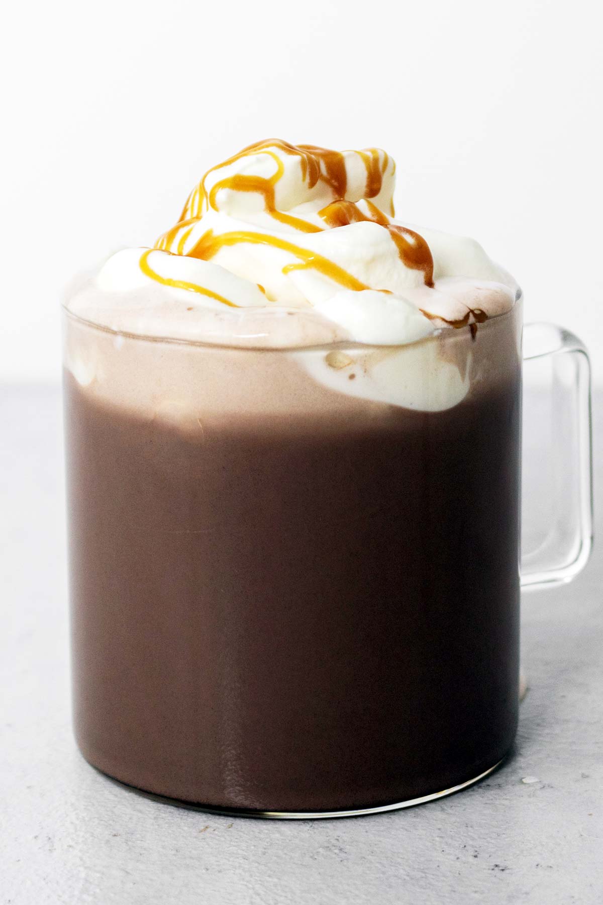 Salted caramel hot chocolate in a mug with whipped cream.