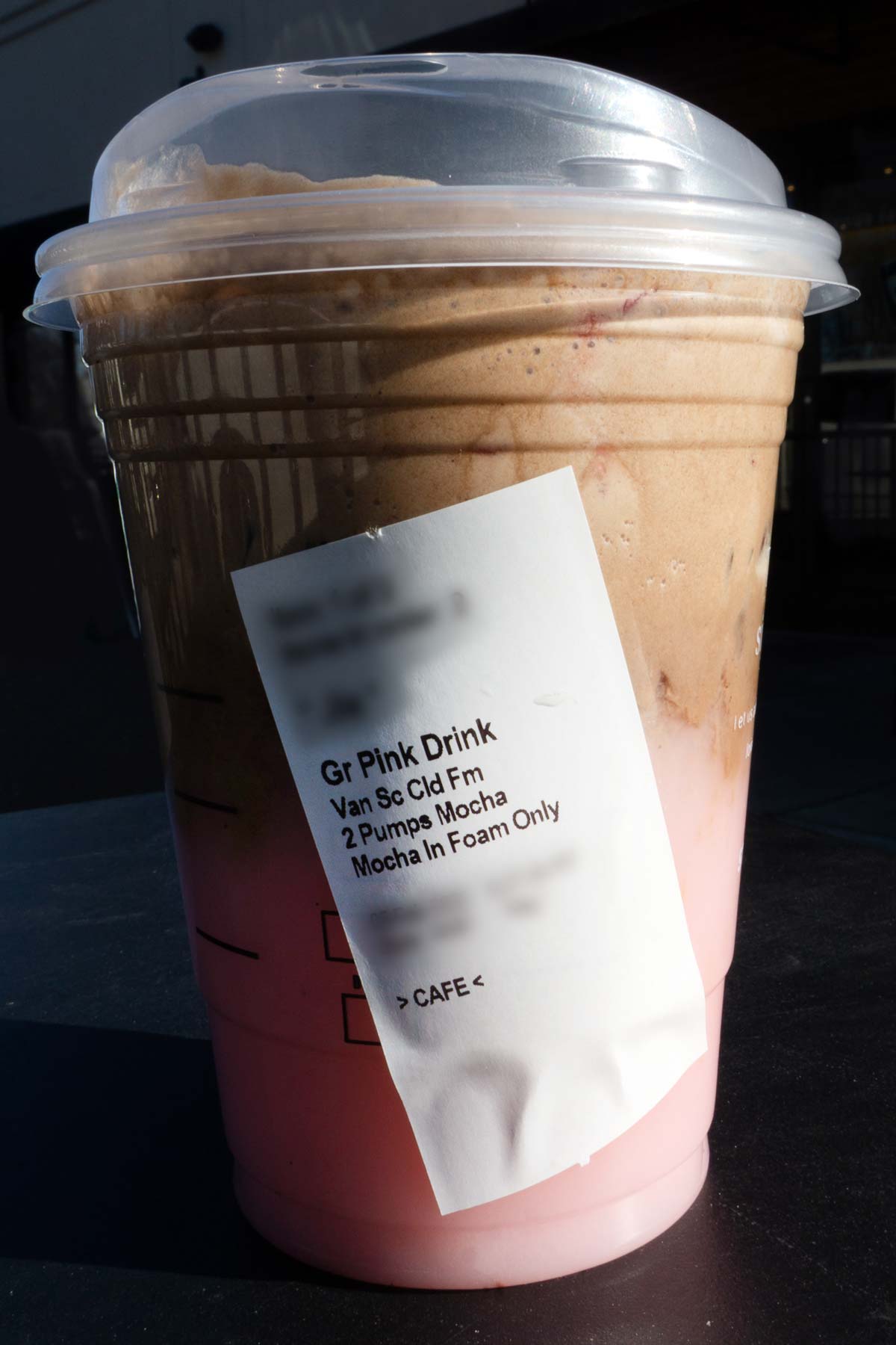 Starbucks Pink Drink in a cup with a lid and ingredients on the label.