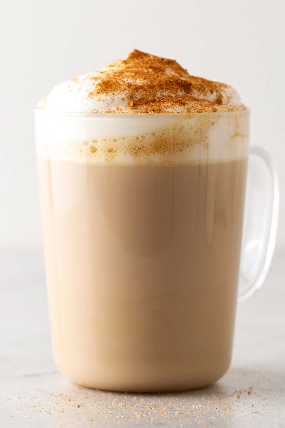 Minuman peniru Starbucks Cinnamon Dolce Latte dalam cangkir kaca.
