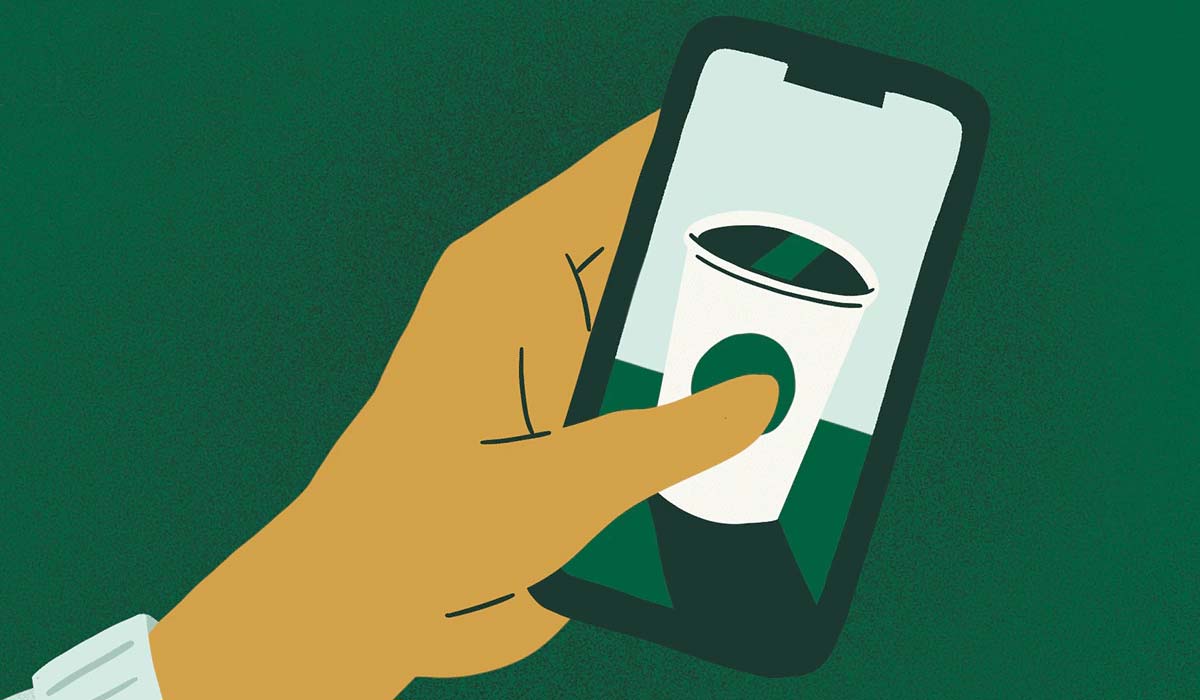 Hand holding a Starbucks app illustration.