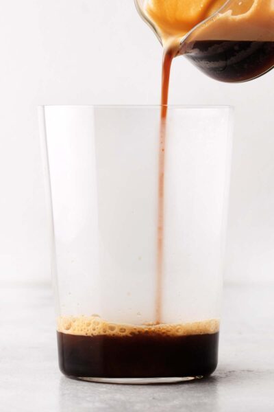 Pouring espresso into a cup.