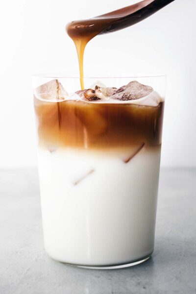 Carmel drizzled on espresso shots, ice, milk, and vanilla syrup, 