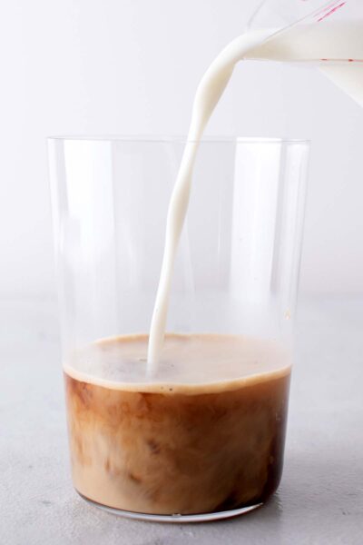 Milk poured into a cup with vanilla and espresso. 