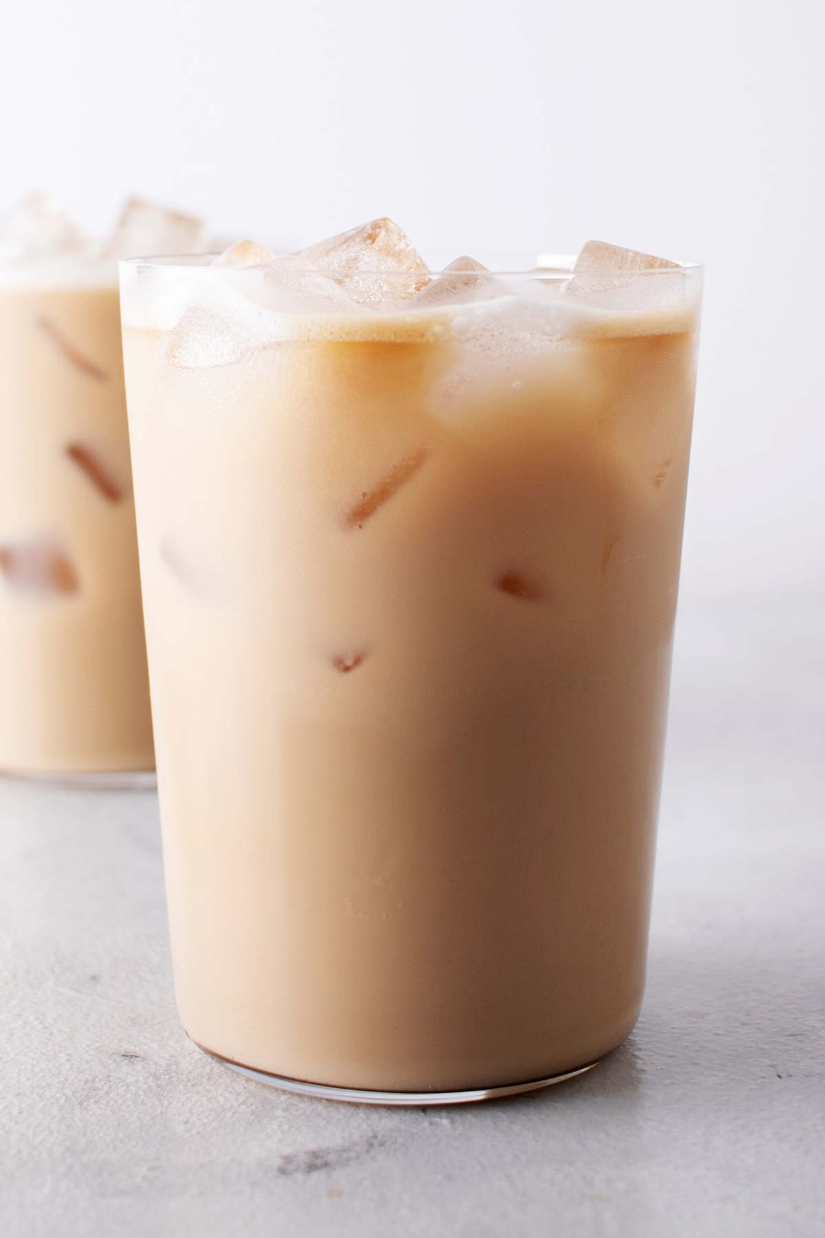 Two glasses filled with Iced Vanilla Latte.