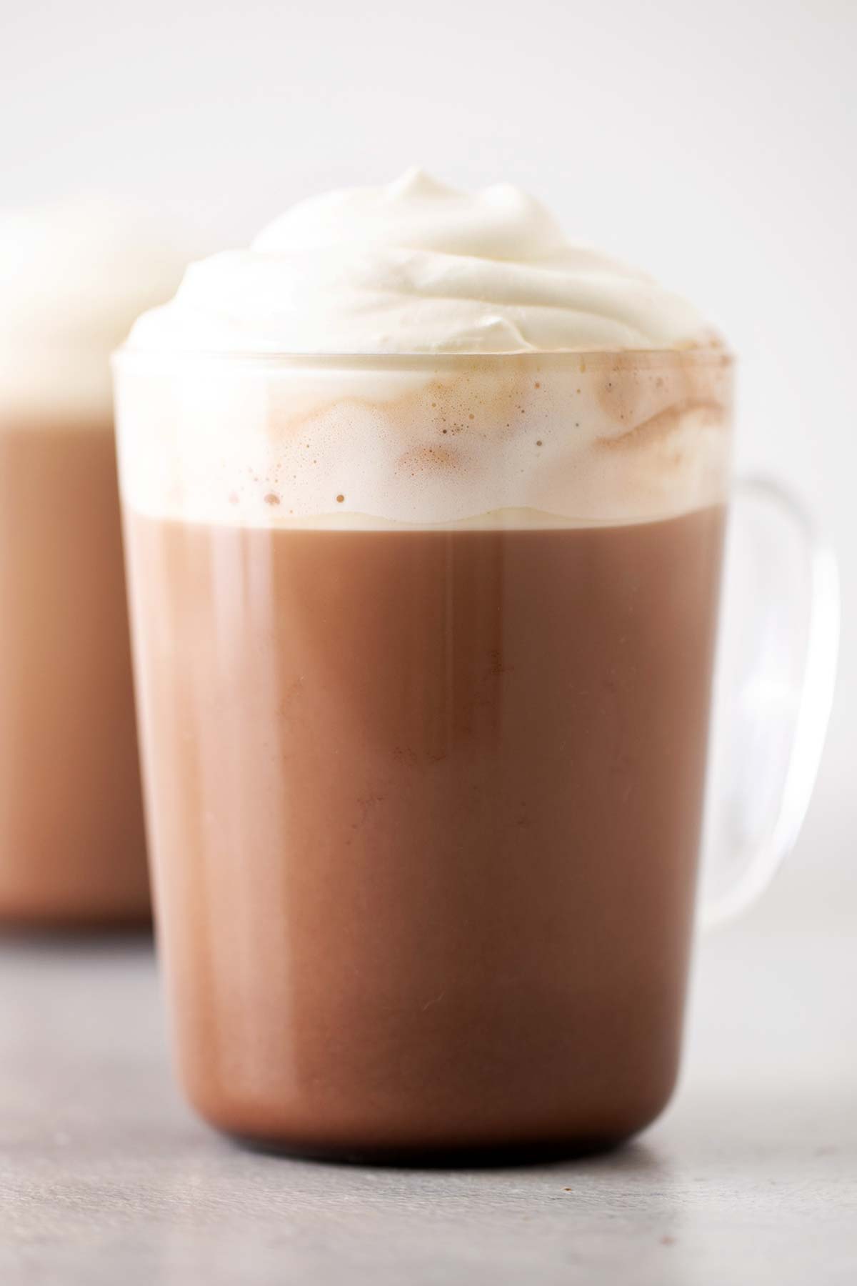 Starbucks Mocha Copycat finished drink in a clear mug and topped with whipped cream.