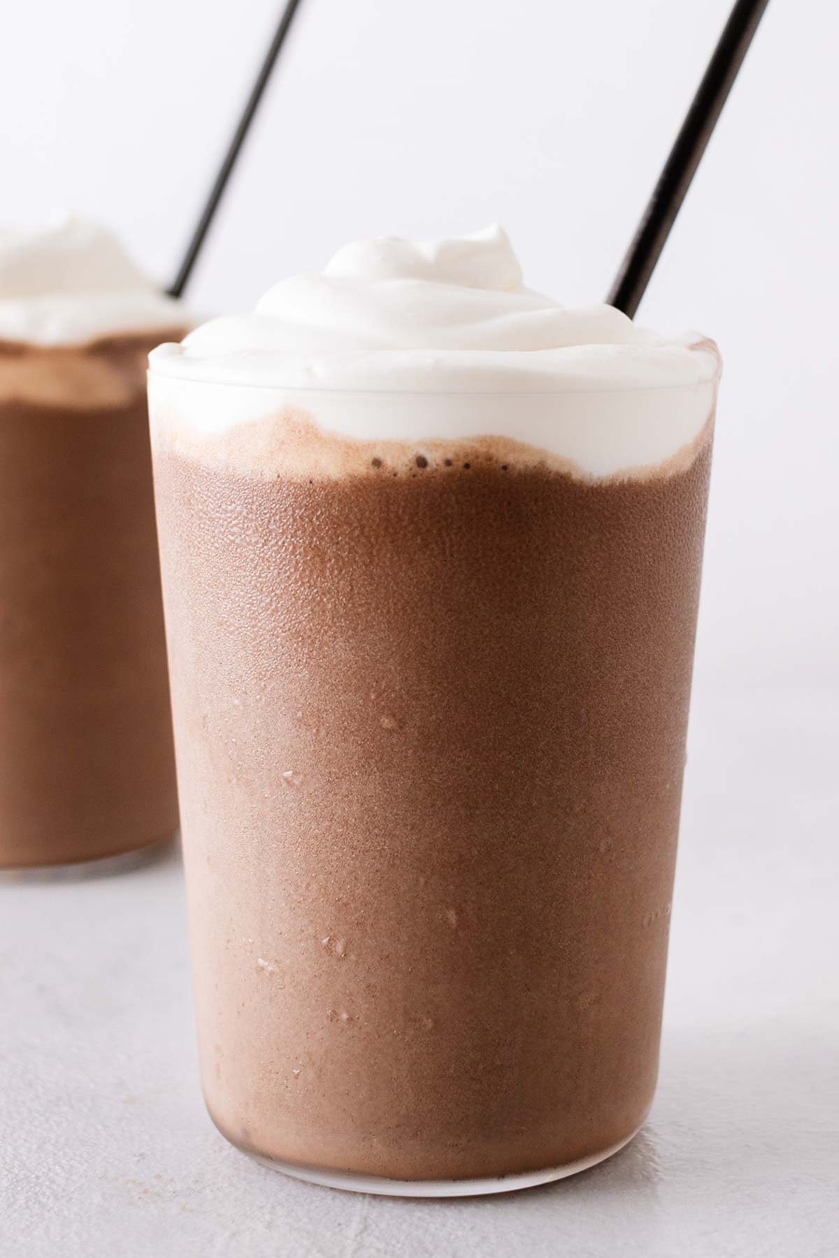 Mocha Frappuccinos in cups with straws.