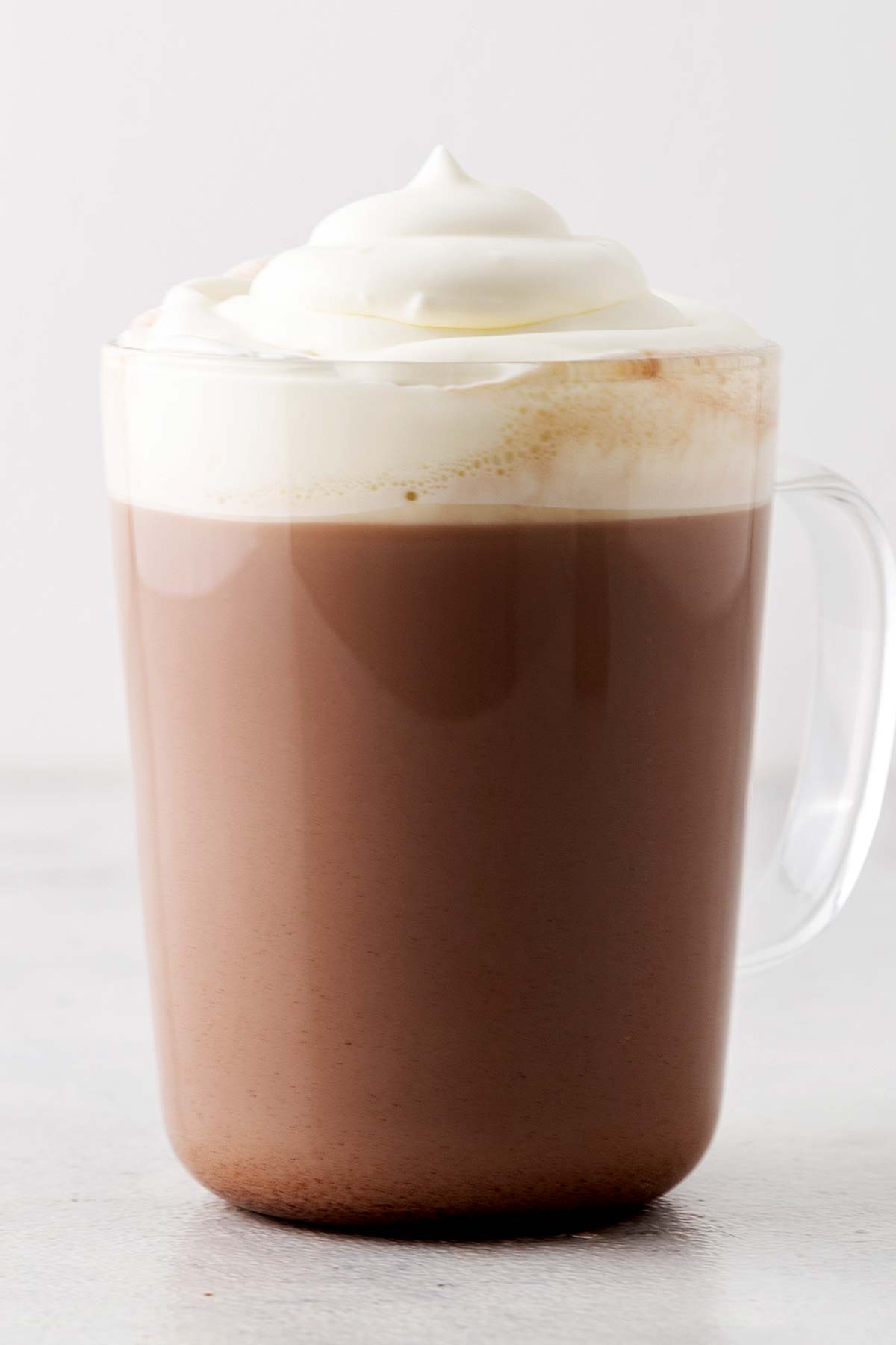 Peppermint hot chocolate in a glass mug.