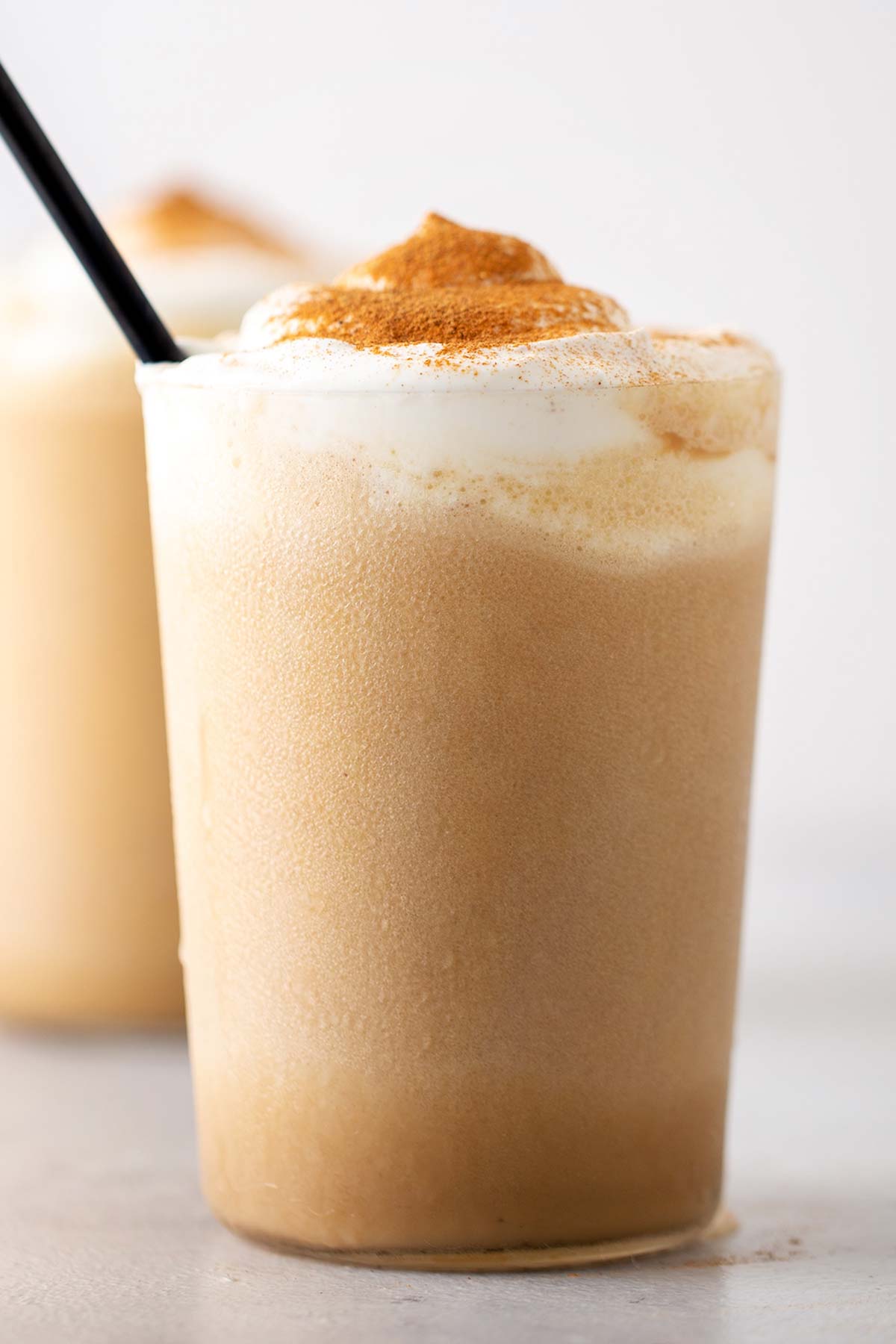 Starbucks Pumpkin Spice Frappuccino copycat drink in a class with a straw.