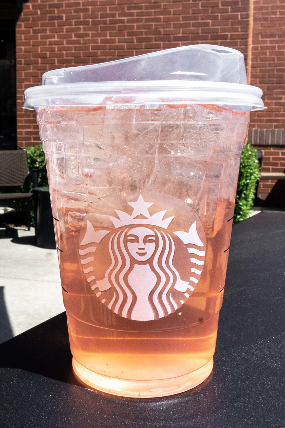 TikTok Rose Gold Refresher in a clear Starbucks cup with a lid.
