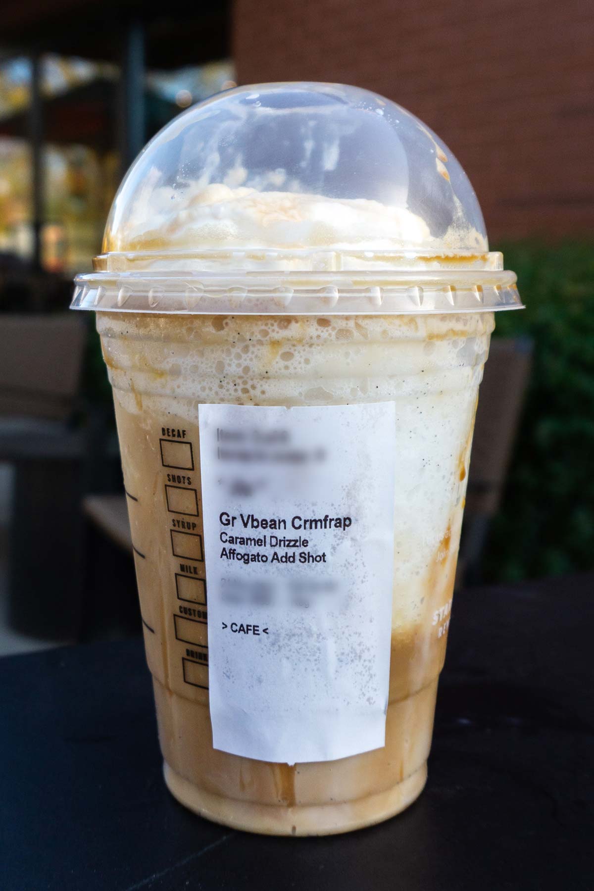 Caramel Macchiato Frappuccino in a cup with order label on the side.