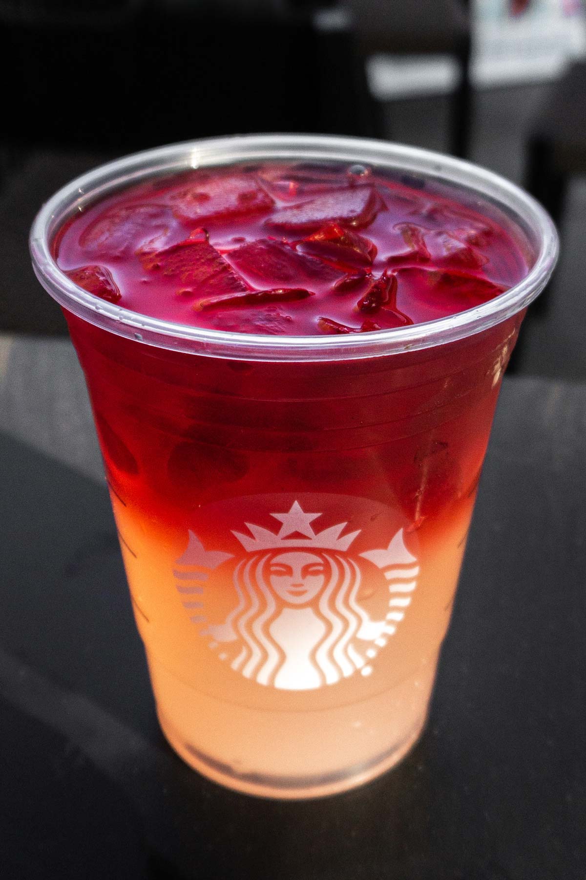 Large cup of Starbucks ombre colored lemonade and iced tea in a cup with ice.