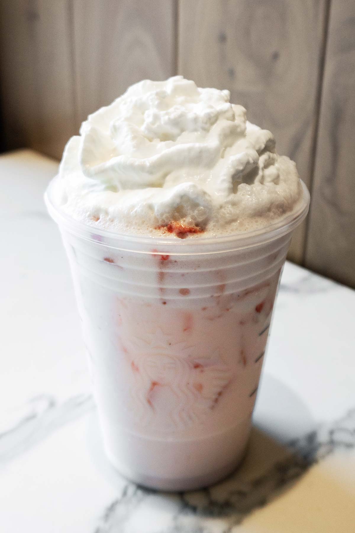 Starbucks Tiktok Pink Drink in a cup with whipped cream.