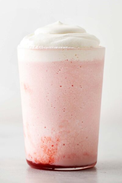 Whipped cream on top of a Strawberry Frappuccino. 