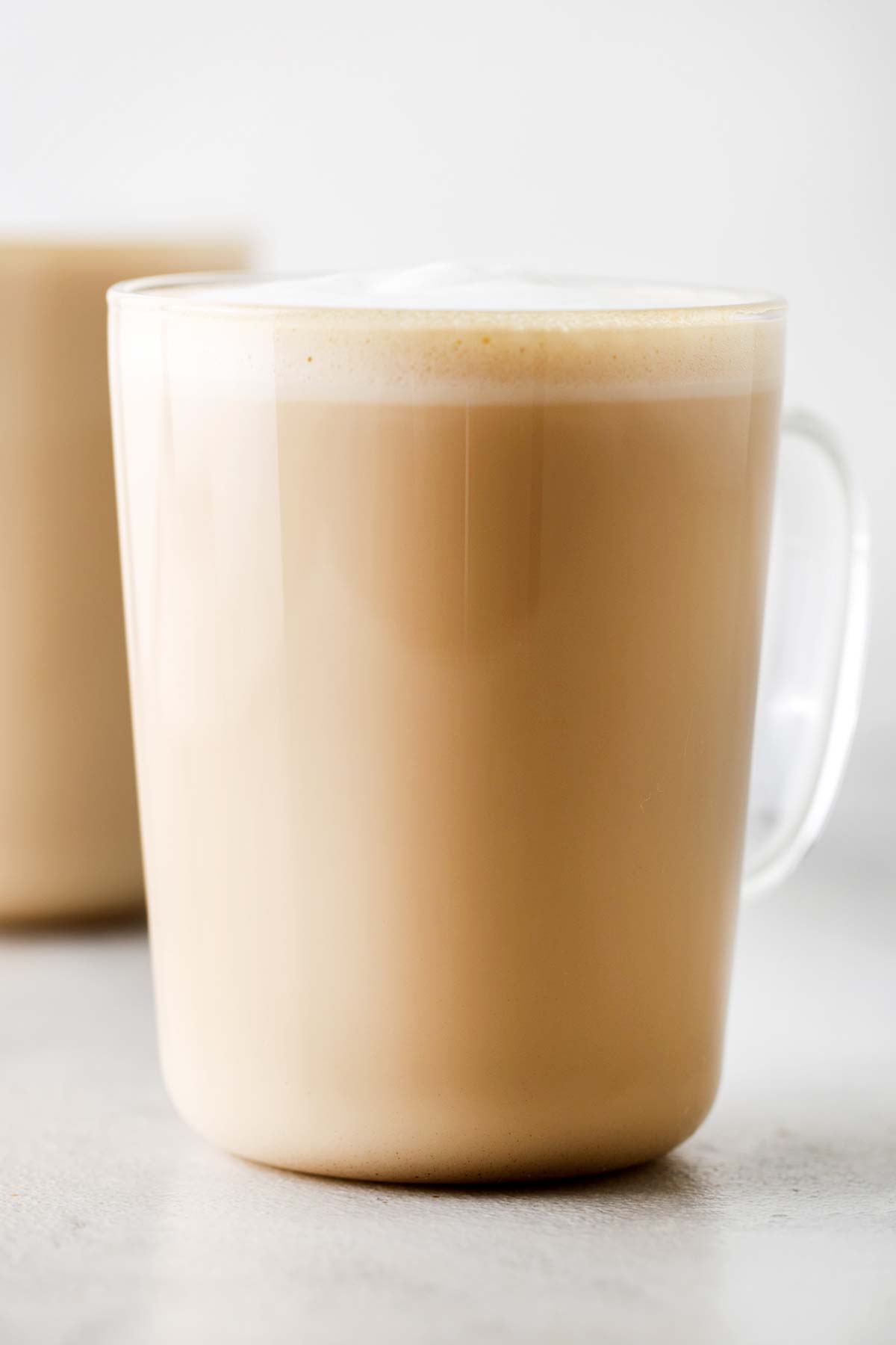 Starbucks Vanilla Latte drink in a clear glass mug.