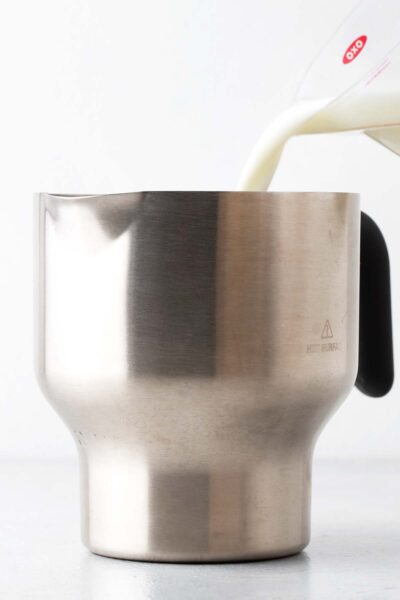 Pouring milk into a milk frother.