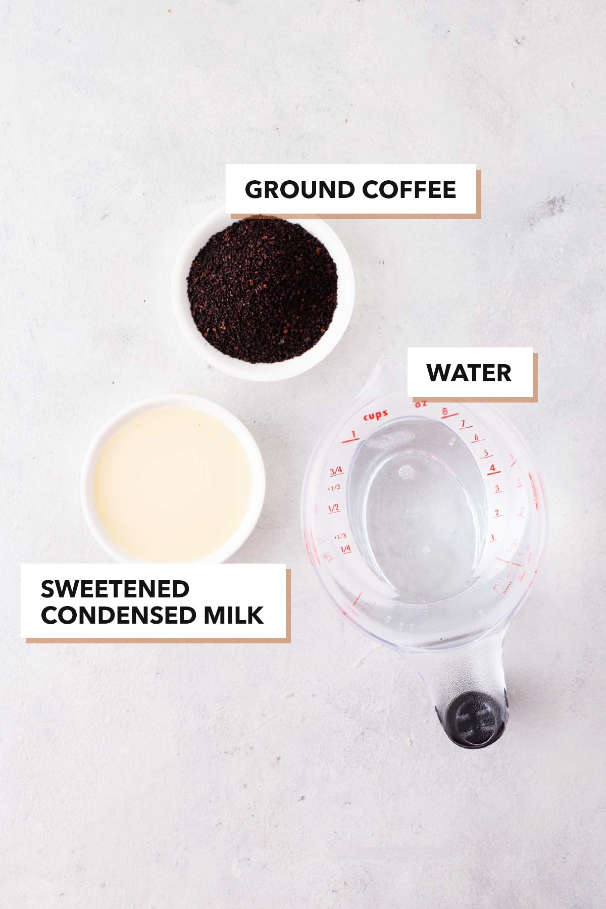 Ingredients for Vietnamese coffee measured in bowls and cups.