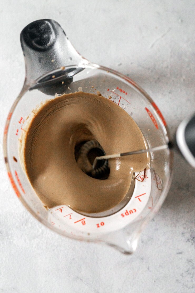 Whisking mocha in a measuring cup.